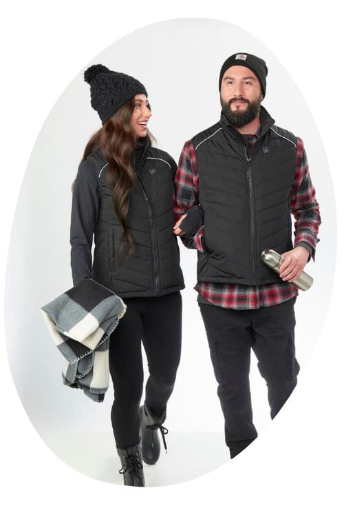 woman looking at man, both wearing winter outerwear - heated apparel